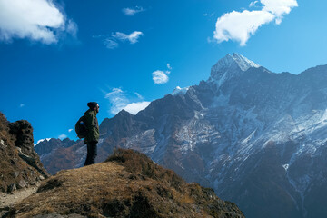 Fototapeta premium Backpacking hiker on his way to achieve his goals. Success, freedom and happiness, achievements in the mountains. Active sport concept, achieve your challenges. photo taken in the khumbu region, nepal