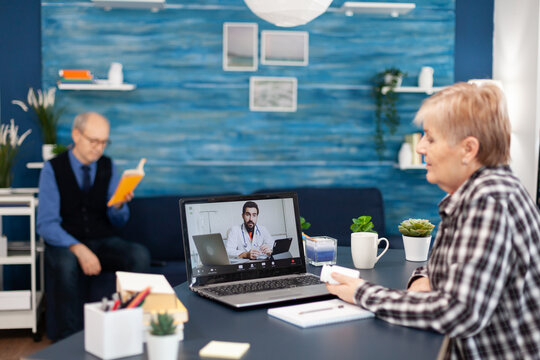 Young Doctor Talking With Senior Patient During Facetime Consultation. Elderly Telemedicine Online Conference Call With Practitioner Doctor Using Modern Healthcare Technology, Web Diagnosis