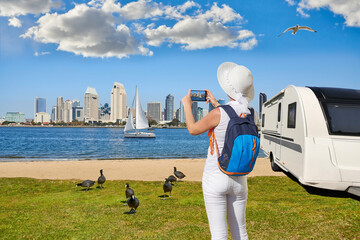 Panoramic View Of Downtown San Diego with caravan or towed trailer on seaside background. Caravan car Vacation. Coastal landscape from Coronado Island California