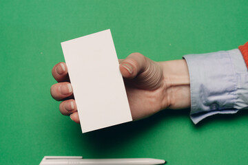 white business cards on bright background and ballpoint pen finance mockups