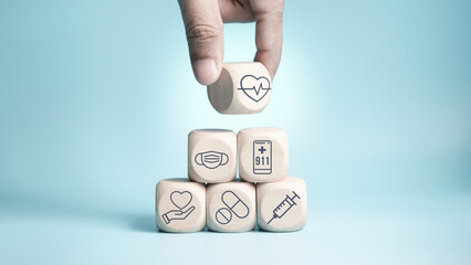 Hand choose wood cube stacking with icon healthcare medical on blue background, Health Insurance...