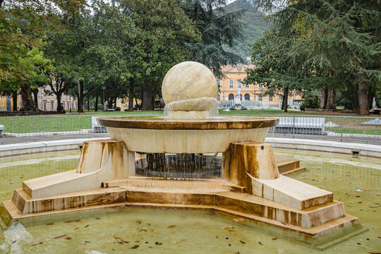 Walking Carrara city streets. View of modern marble fountain of Piazza D'Armi in the central square of Carrara, Italy