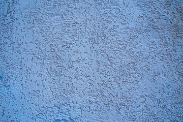 texture of blue wall covered with volumetric plaster, space for text, space for copy