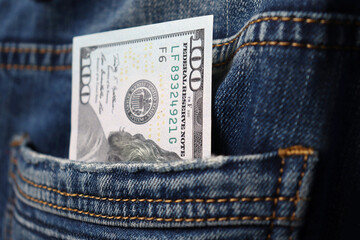 Money in your pocket. Bills in the back pocket of jeans. The concept of pocket money. Cash. Money of various denominations. Close-up. Business, trade or financial transactions.