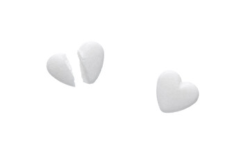 White pills in the shape of a heart isolated on white background. 
pills sliced in half.