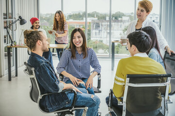 Group Of Asian and Multiethnic Business people with casual suit in happy action brainstorming and helping the share the idea in the modern workplace, people business group concept
