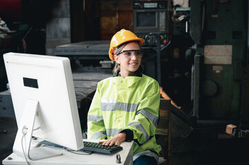 Inside the Heavy Industry, Factory Female Industrial Engineer Works on Personal Computer and she is smile