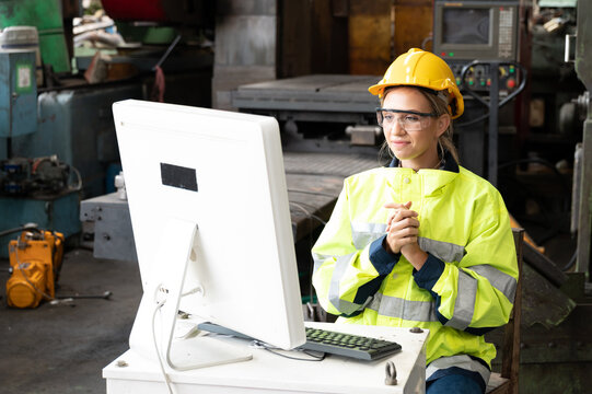 Inside The Heavy Industry, Factory Female Industrial Engineer Works On Personal Computer She Is Thinking