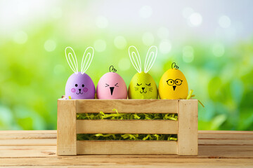 Easter holiday concept with colorful Easter eggs as cute bunny and chicken characters in box on...