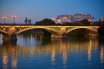 Fototapeta na wymiar Isabel II bridge or Triana bridge, in Guadalquivir river at Evening,Sevilla,Andalucía,Spain, Europe.