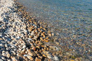 Clean water and stony bottom of the Baikal Lake at summer sunny day. Concept of relaxation, nature. Vocation time. Sea scene for card. Selective focus.