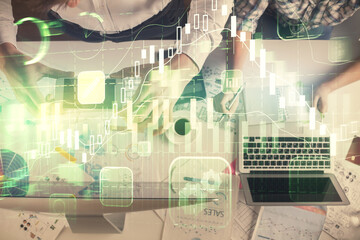 Double exposure of man and woman working together and financial chart hologram drawing. market analysis concept. Computer background. Top View.