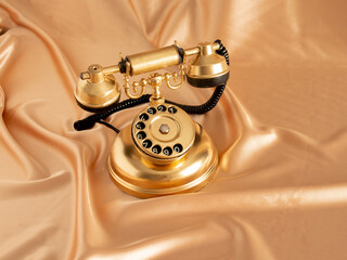 golden retro old phone on golden bright background. minimal abstract creative idea