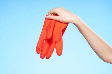 rubber glove in hand cleaning service blue background