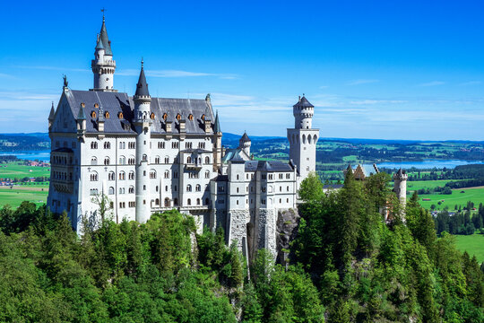 View of famous and amazing Neuschwanstein Castle, near F&uuml;ssen, Bavaria, Germany, seen from the Marienbr&uuml;cke (Mary's Bridge), a pedestrian bridge built over a cliff