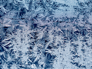 Ice crystals in the detail on a window glass in winter time
