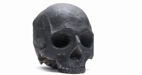 Dark skull rotating against white isolated background