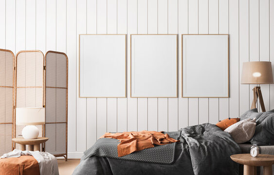 Frame mockup in coastal bright bedroom, rattan furniture and orange bedding in trendy decoration, 3d render