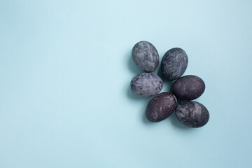 Easter background with blue cosmic eggs on blue background with copy space. Happy Easter 2021.