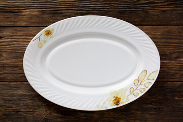 White empty dish on wooden background