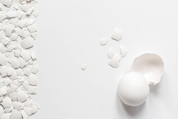 White eggshell of a broken chicken egg with shards isolated on a white background. Easter.View from...