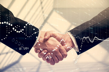 Double exposure of data theme hologram and handshake of two men. Partnership in IT industry concept.