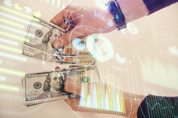 Multi exposure of technology drawing hologram and us dollars bills and man hands. Data concept
