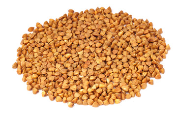 Side view of heap of buckwheat groats isolated on white background.