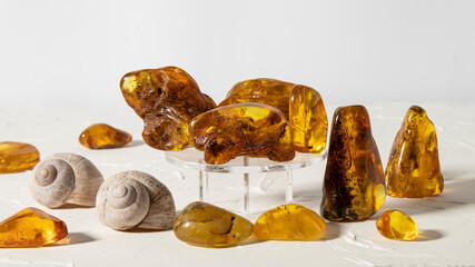 Set of glittering yellow and orange amber stones on a white background. Transparent amber stones with plant inclusion, opaque yellow.  Amber texture, material for jewelers, stone healing. 