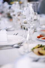 beautifully laid tables with glasses and appliances at morning in restaurant