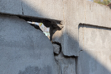 Concrete walls that have so much cracked into large holes.