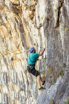 Climber climbs on the rock wall. Climbing gear. Climbing equipment.