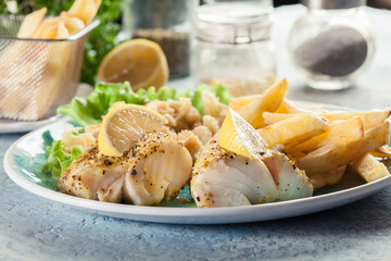 Steamed cod fish with french fries and boiled cauliflower