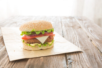 Delicious fast food. Homemade hamburger. Homemade, beef hamburger with cheese and vegetables.