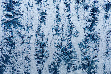 Ice crystals in the detail on a window glass in winter time
