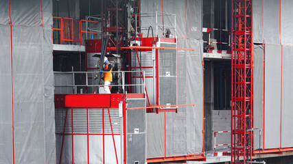 Elevators used for worker and moving materials in Construction site, Passenger lift system outdoor...