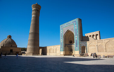 central asia town central square with madrasah and minaret under the summer heat 