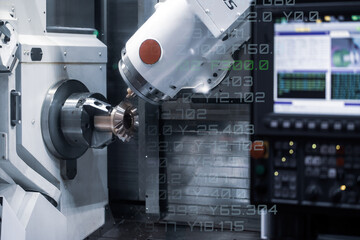 CNC milling or turning machine cutting bevel gear with milling spindle. Mutitasking CNC lathe...