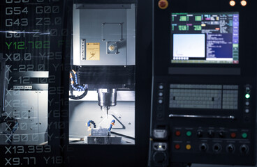 CNC milling machine cutting automotive part. CNC programming code. Industrial manufacturing...
