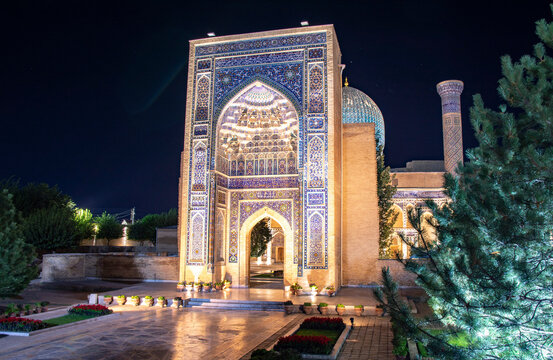 night view of Tamerlan Tomb in Samarkand with backlight and trees around 