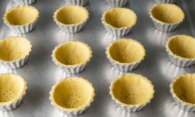 Making cheese tarts crust. Selective focus.