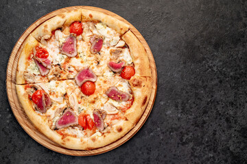 delicious meat pizza on a stone background  with copy space for your text