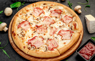 pizza with bacon, mushrooms and cheese on a stone background