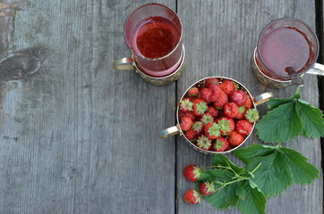Berry strawberry tea and fresh garden strawberries on wooden background