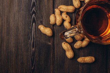 beer mug peanuts in shell wooden table top view