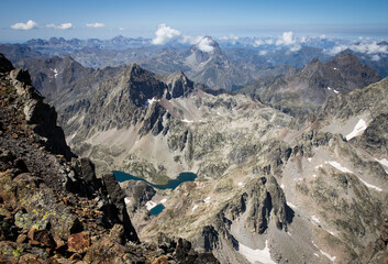 Spectacular view of the Pyrenees mountain range from the top of a mountain, with lakes below