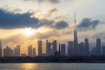 Obraz premium Dubai, UAE - 03.06.2021 Dubai public beach with city skyline on background.Sunrise hour. Outdoor