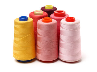 spools of thread for the textile industry on white background