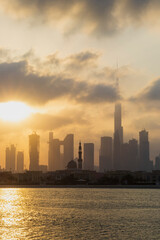 Fototapeta na wymiar Dubai, UAE - 03.06.2021 Dubai public beach with city skyline on background.Sunrise hour. Outdoor