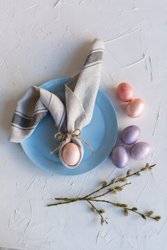 Napkin in the shape of Easter bunny. A variant of a festive table setting. Easter